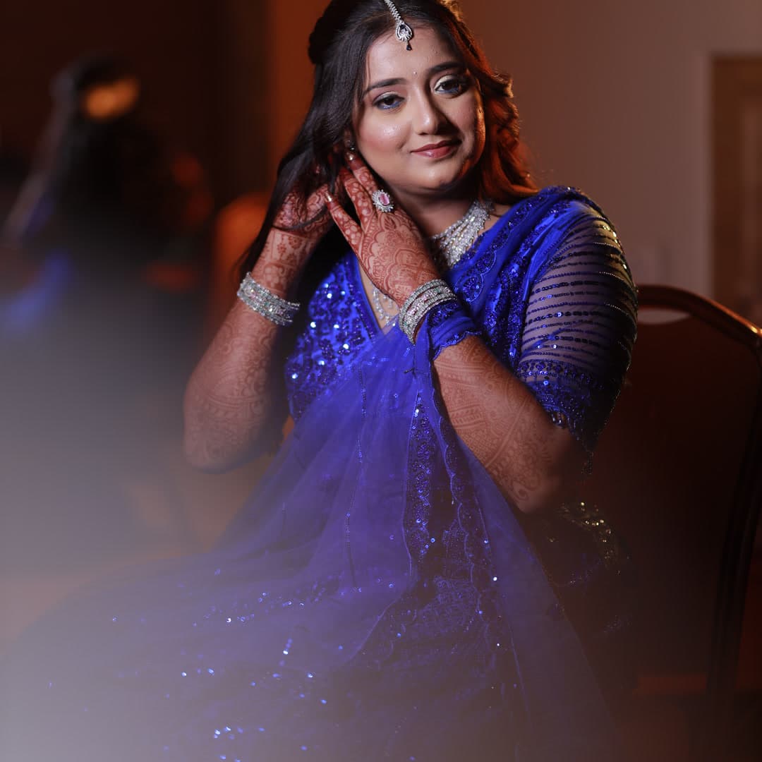Woman in royal blue saree wearing diamond jewelry