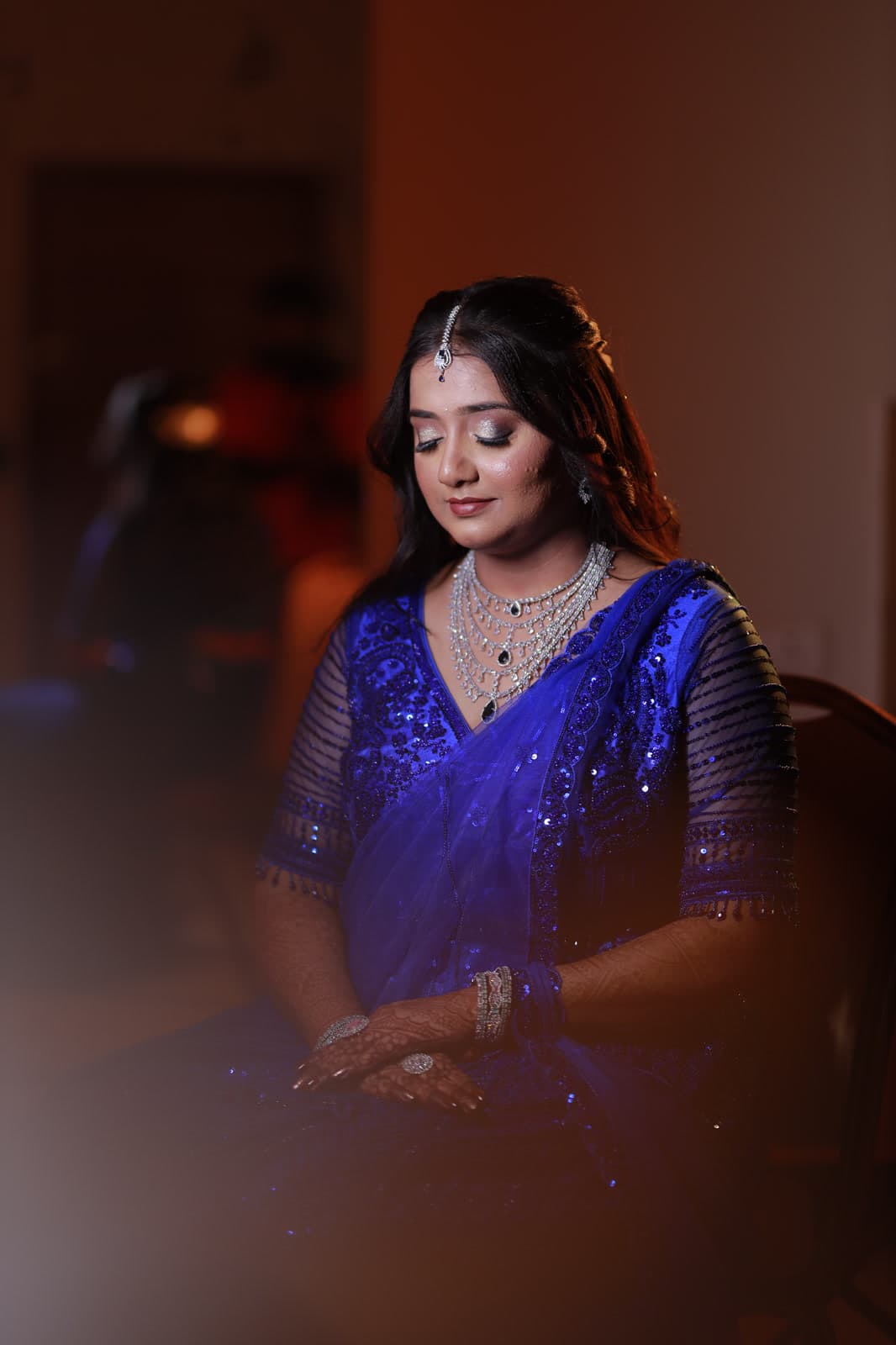 Woman in traditional attire in a contemplative seated pose
