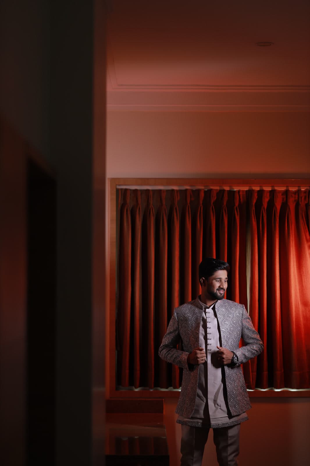 Man standing in a doorway with warm rim lighting