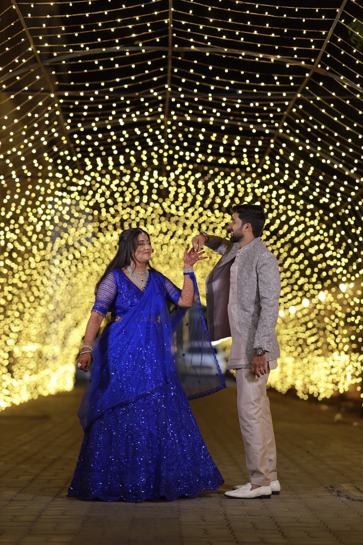 Couple dancing in a tunnel of fairy lights